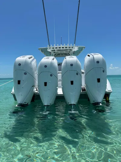  Yacht Photos Pics 2024 Yellowfin 39 boat with four powerful outboard engines in clear blue water.