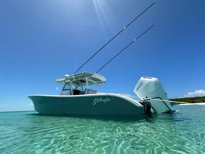  Yacht Photos Pics 2024 Yellowfin 39 boat in clear blue water under sunny sky.