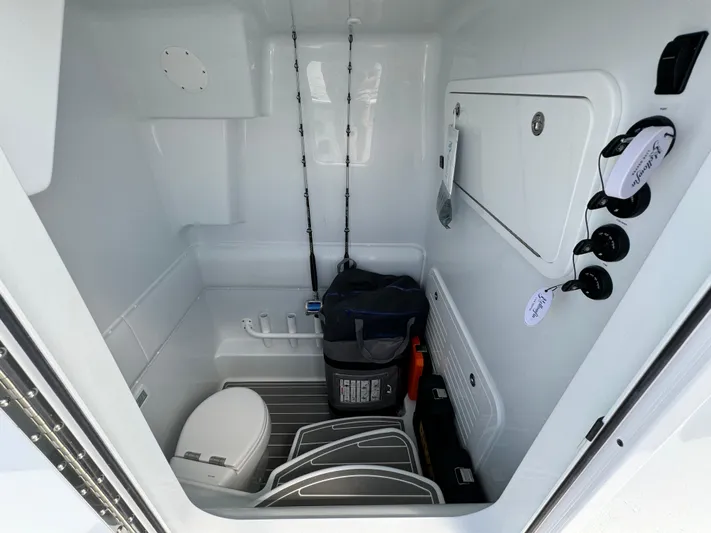  Yacht Photos Pics Interior of 2024 Yellowfin 39 boat with storage, toilet, and fishing rods.