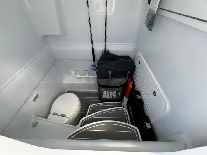  Yacht Photos Pics 2024 Yellowfin 39 boat interior with fishing gear and toilet.
