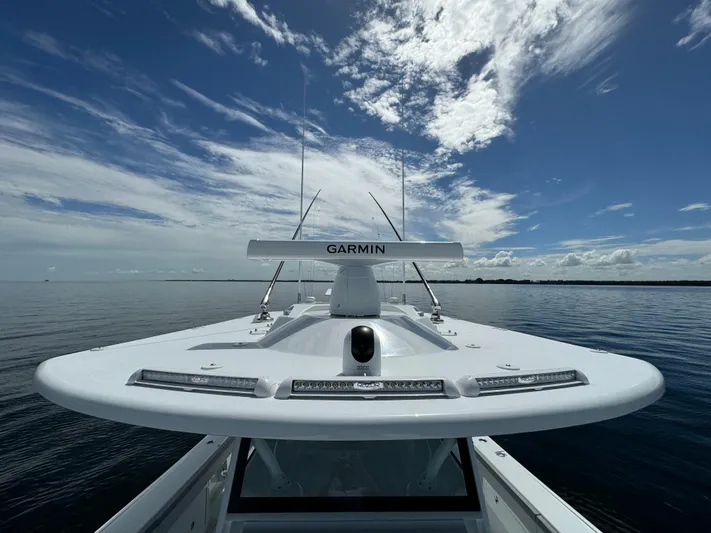  Yacht Photos Pics 2024 Yellowfin 39 boat with Garmin radar on calm waters under a partly cloudy sky.