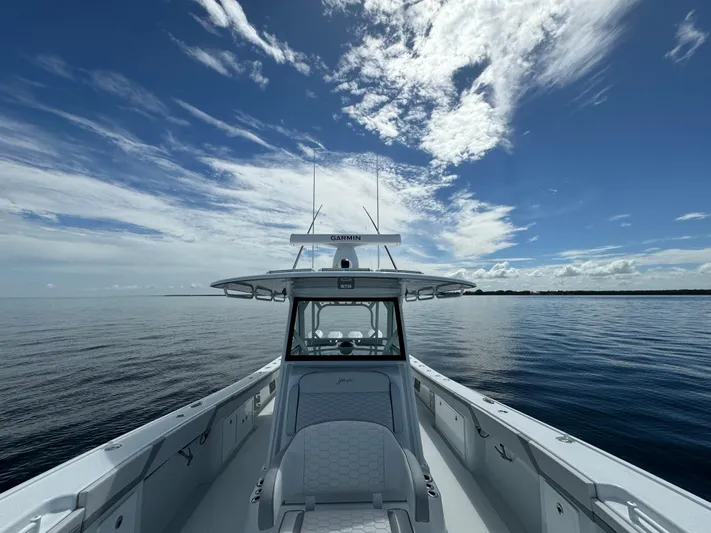  Yacht Photos Pics 2024 Yellowfin 39 boat on calm ocean under a partly cloudy sky.