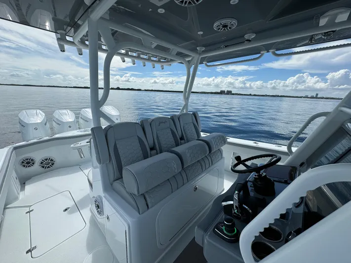  Yacht Photos Pics 2024 Yellowfin 39 boat interior with helm and seating, ocean view in background.