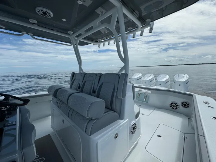  Yacht Photos Pics 2024 Yellowfin 39 boat interior with cushioned seating and multiple outboard engines.
