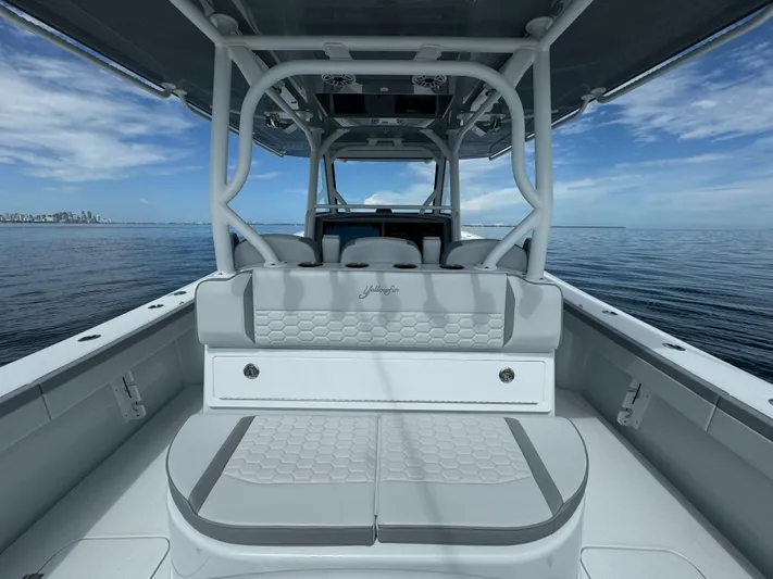  Yacht Photos Pics 2024 Yellowfin 39 boat interior with cushioned seating on calm ocean.