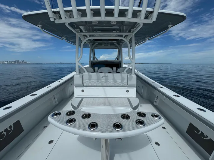  Yacht Photos Pics 2024 Yellowfin 39 boat with spacious deck and rod holders on calm ocean.