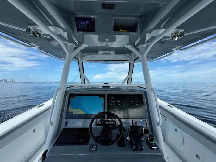  Yacht Photos Pics 2024 Yellowfin 39 boat helm with advanced navigation system on open water.