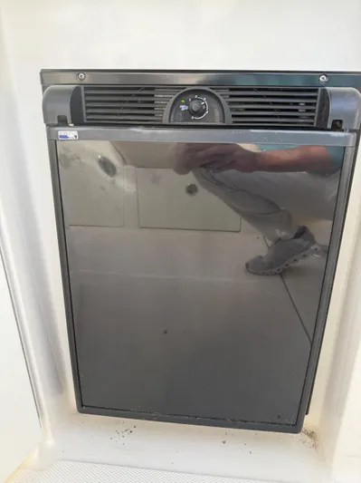 Rollin With The Flow Yacht Photos Pics 2012 Sea Ray 310 Sundancer boat refrigerator, sleek design, reflective surface.