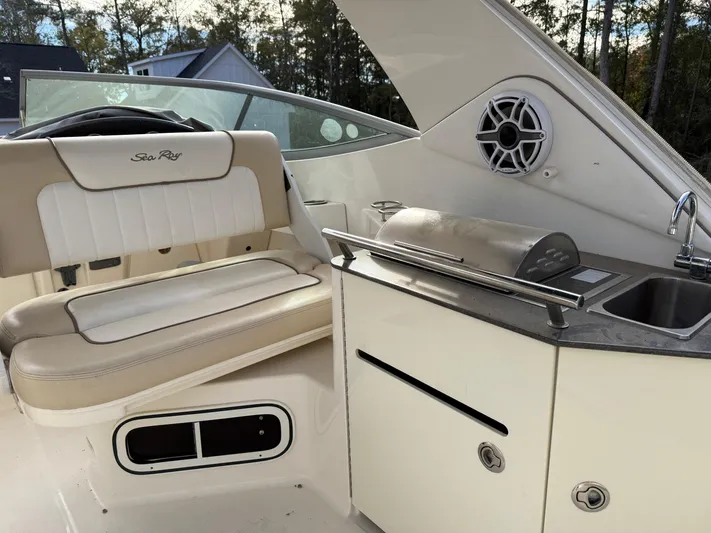 Rollin With The Flow Yacht Photos Pics Interior of 2012 Sea Ray 310 Sundancer boat with seating and kitchenette area.