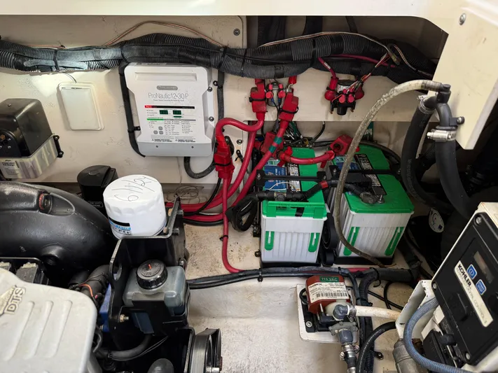 Rollin With The Flow Yacht Photos Pics Engine compartment of a 2012 Sea Ray 310 Sundancer with batteries and wiring.