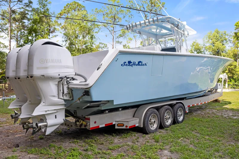  Yacht Photos Pics 2016 SeaHunter 41 Tournament boat on trailer with triple Yamaha engines, parked outdoors.