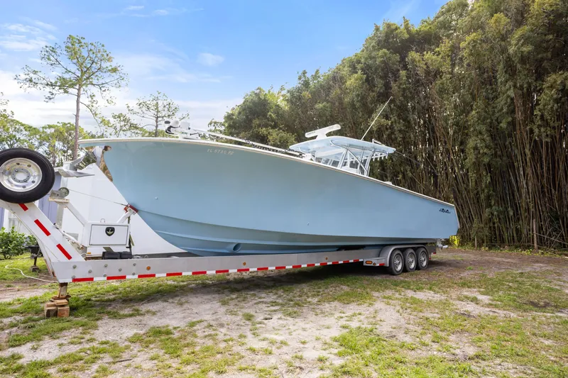  Yacht Photos Pics 2016 SeaHunter 41 Tournament boat on trailer, parked outdoors near trees.