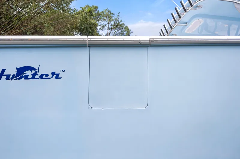  Yacht Photos Pics 2016 SeaHunter 41 Tournament boat side view with logo, blue hull, and rod holders.