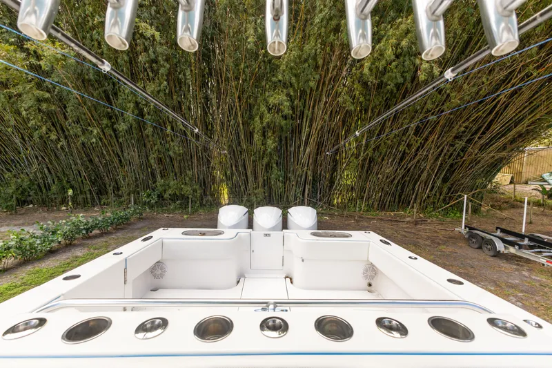  Yacht Photos Pics 2016 SeaHunter 41 Tournament boat with rod holders, set against lush bamboo backdrop.