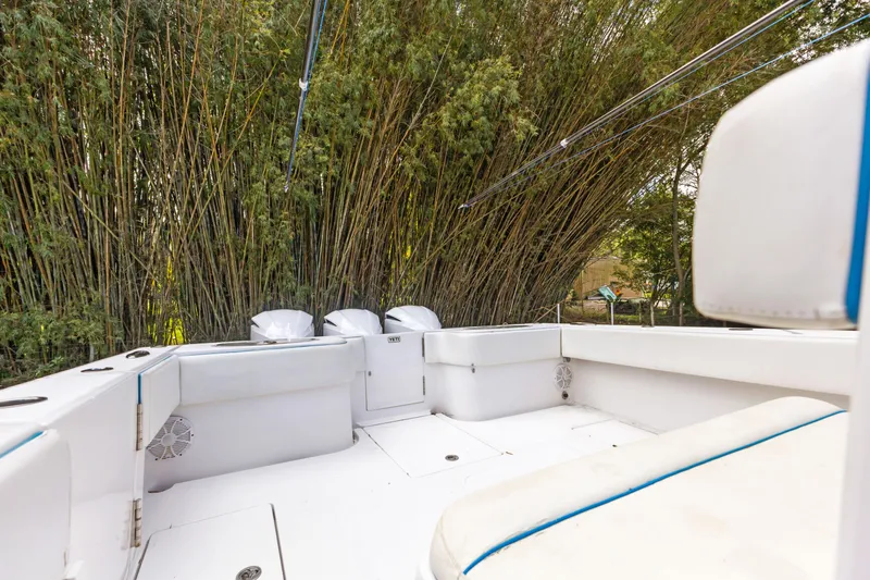  Yacht Photos Pics 2016 SeaHunter 41 Tournament boat interior with white seating and lush bamboo backdrop.