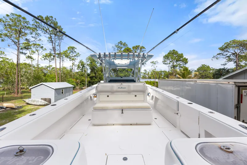  Yacht Photos Pics 2016 SeaHunter 41 Tournament boat deck with seating, surrounded by trees and blue sky.