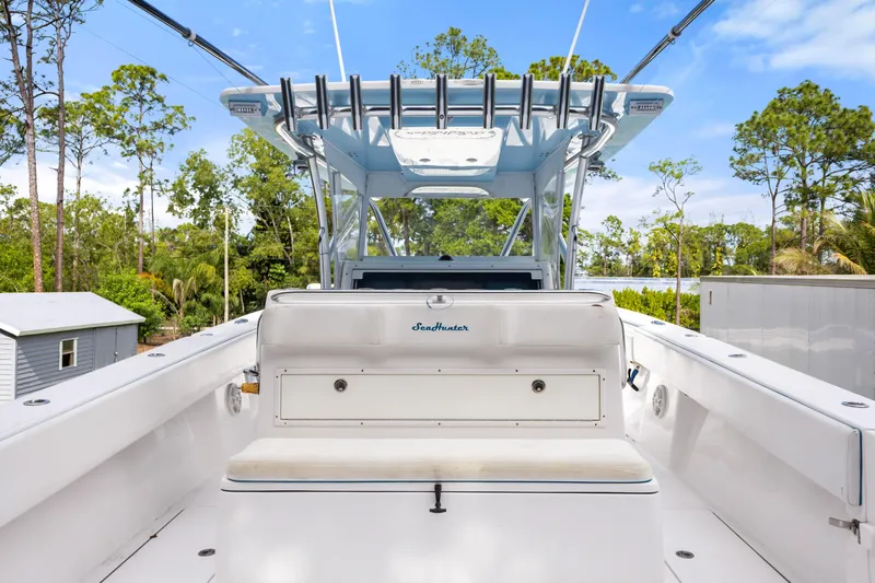  Yacht Photos Pics 2016 SeaHunter 41 Tournament boat interior with seating and canopy, surrounded by trees.