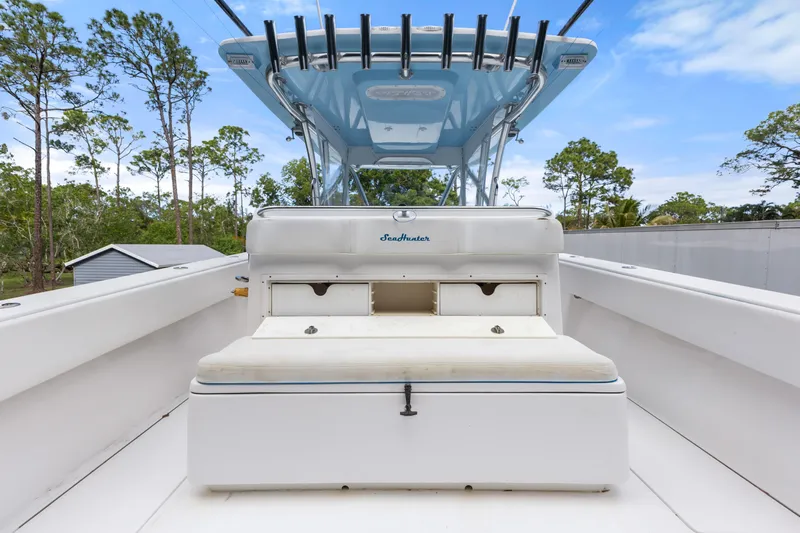  Yacht Photos Pics 2016 SeaHunter 41 Tournament boat interior with seating and storage, surrounded by trees.