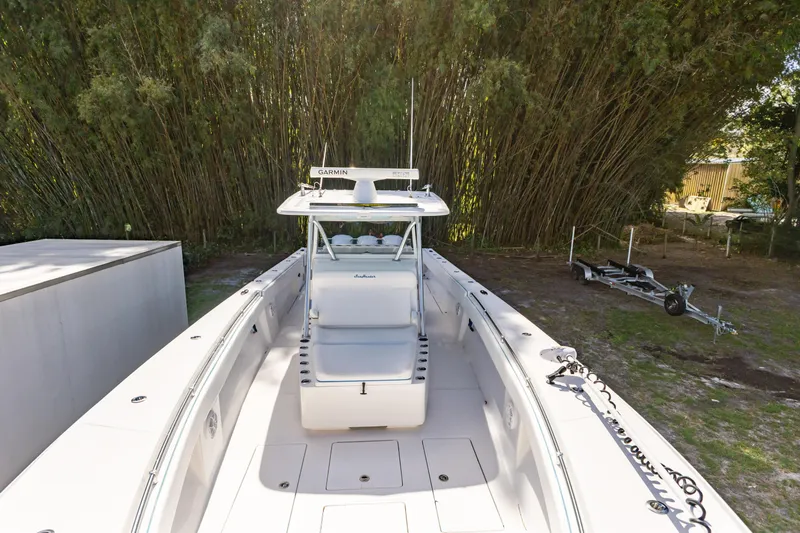  Yacht Photos Pics 2016 SeaHunter 41 Tournament boat with Garmin equipment, parked near lush greenery.