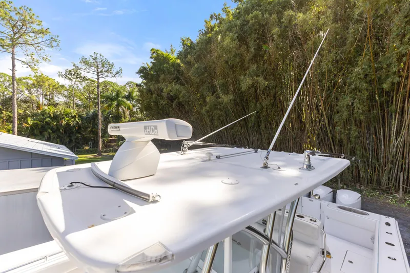  Yacht Photos Pics 2016 SeaHunter 41 Tournament boat with radar and antennas, surrounded by lush greenery.