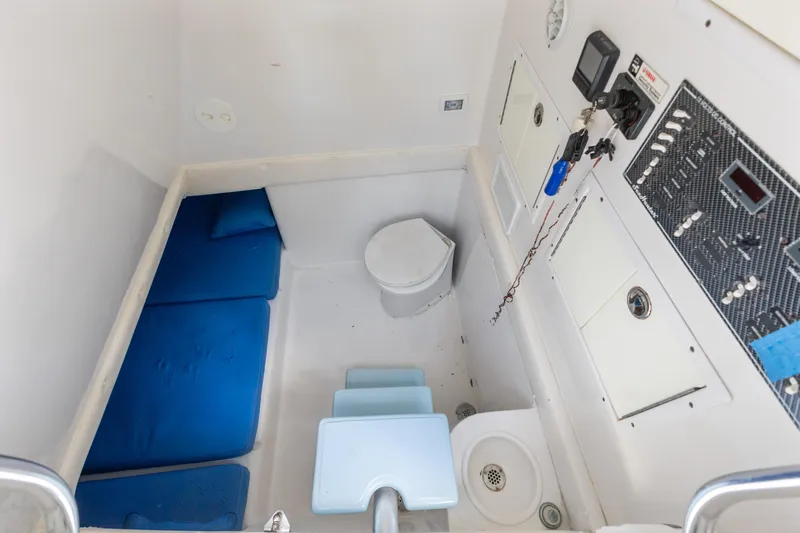  Yacht Photos Pics 2016 SeaHunter 41 Tournament cabin interior with blue cushions and control panel.