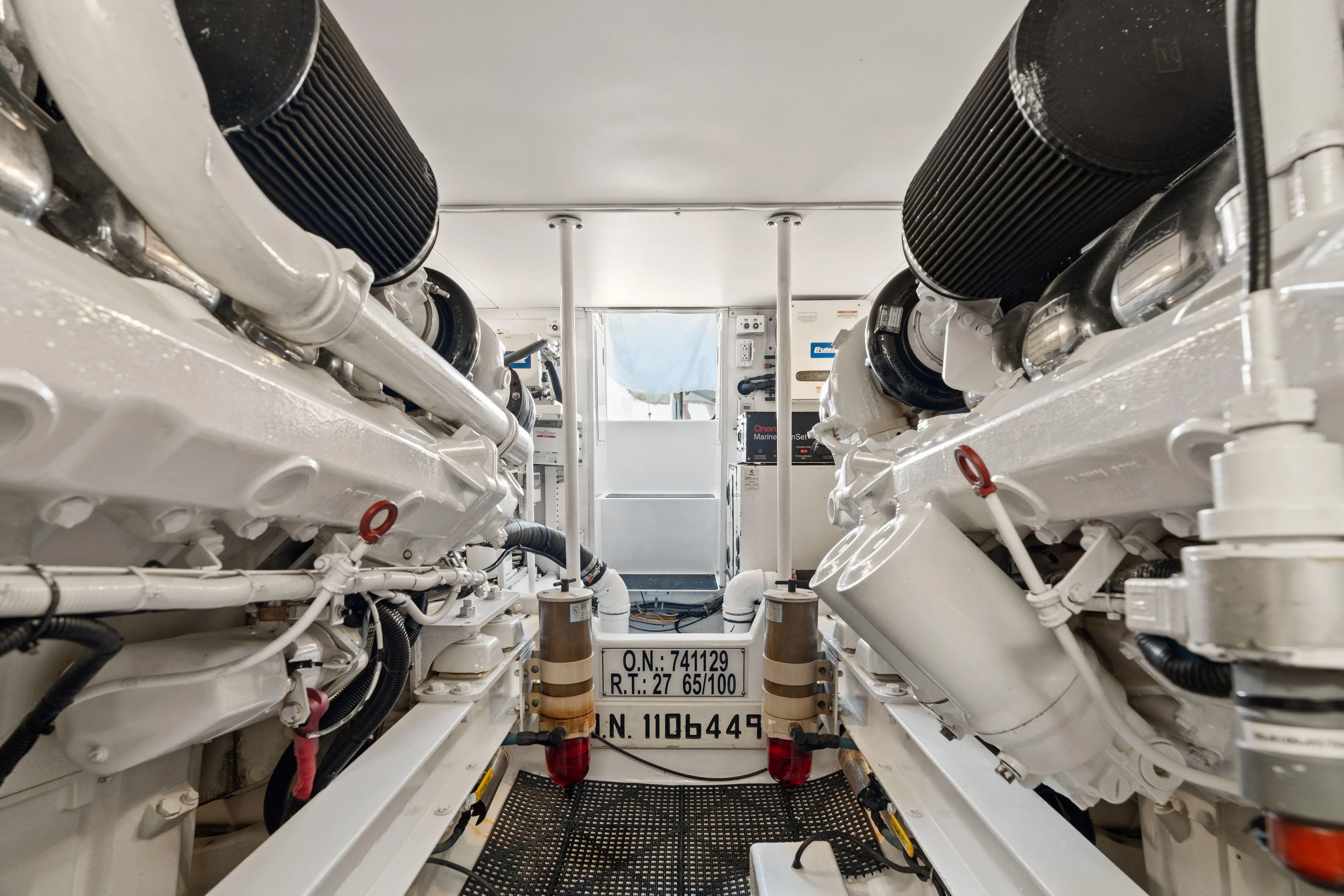 All Keyed Up Yacht Photos Pics Engine room of 2001 Viking 50 Express yacht, showcasing dual engines and mechanical components.