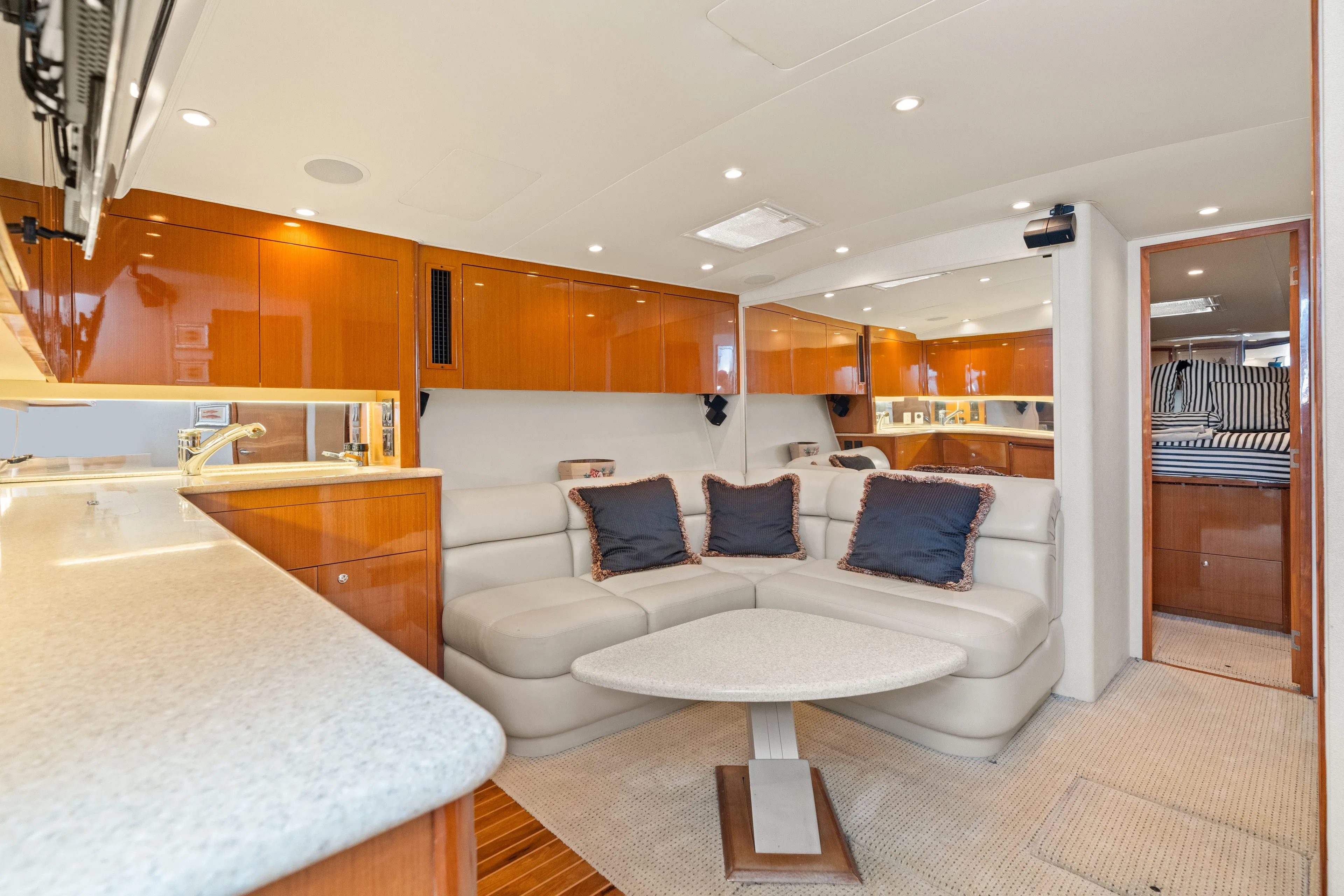 All Keyed Up Yacht Photos Pics Luxurious interior of 2001 Viking 50 Express yacht with modern seating and elegant cabinetry.
