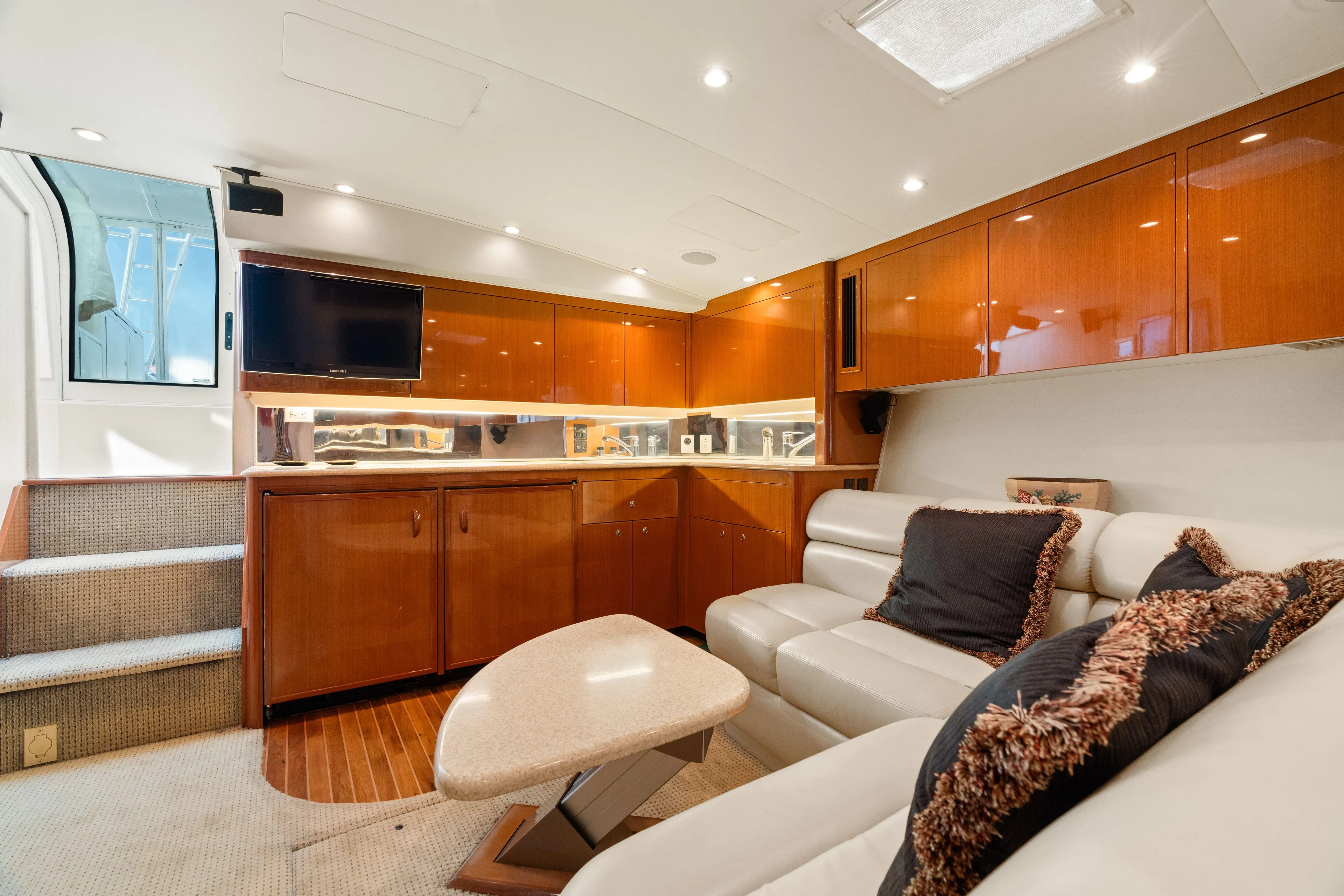 All Keyed Up Yacht Photos Pics Luxurious interior of a 2001 Viking 50 Express yacht with modern furnishings and wood cabinetry.