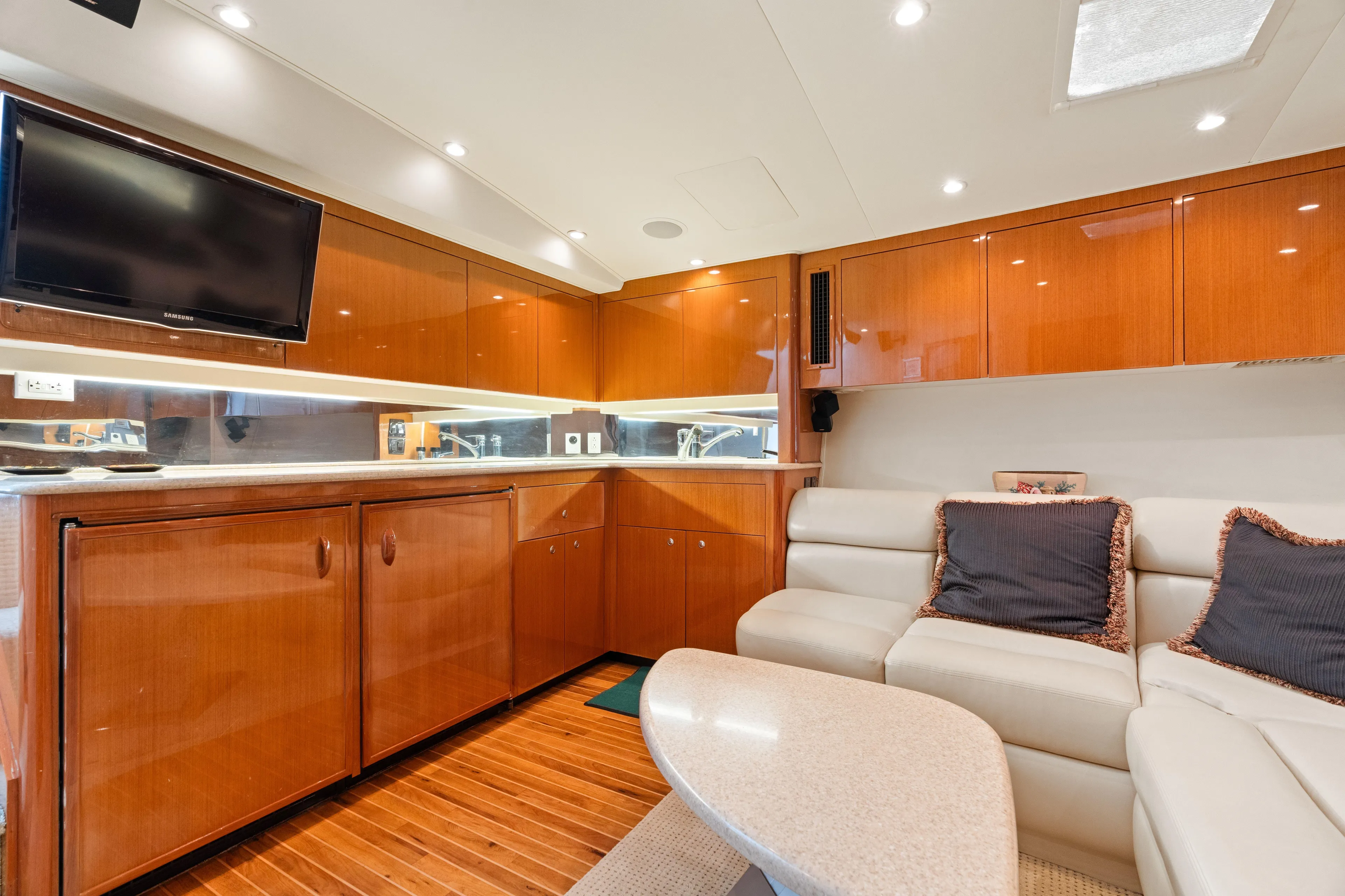 All Keyed Up Yacht Photos Pics Luxurious interior of 2001 Viking 50 Express yacht with sleek wood cabinetry and plush seating.