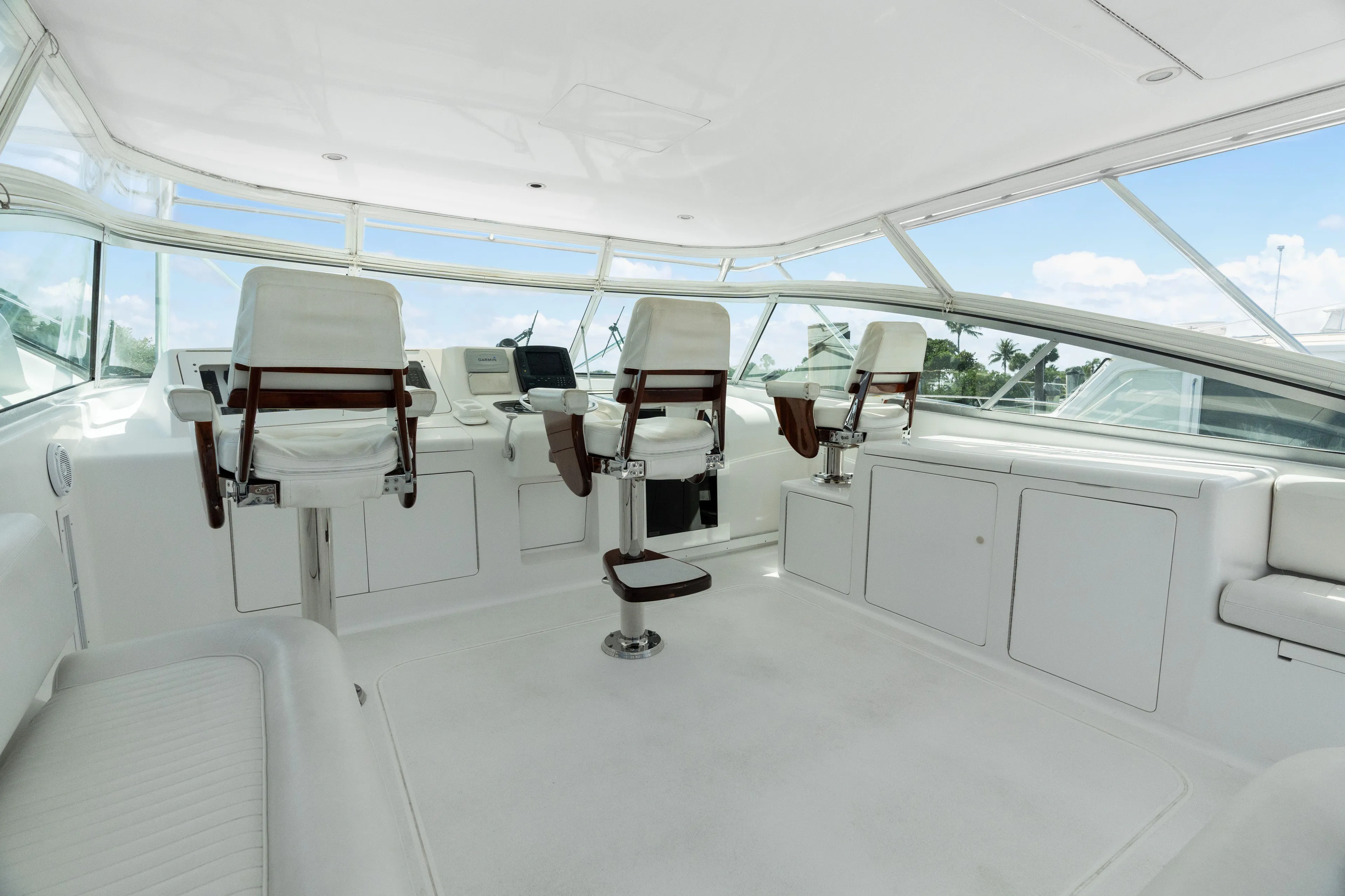 All Keyed Up Yacht Photos Pics Interior of 2001 Viking 50 Express yacht with white seating and navigation equipment.