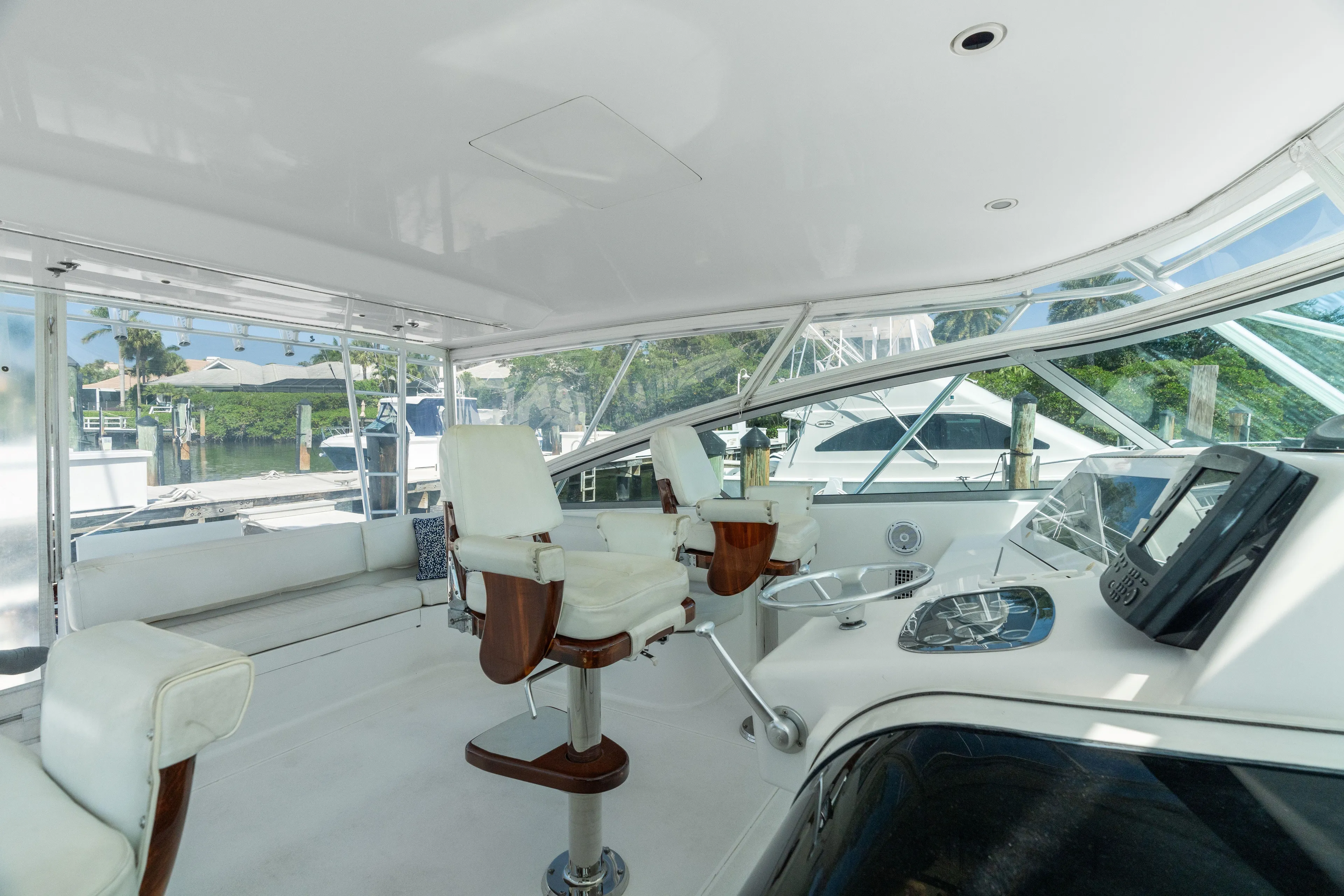 All Keyed Up Yacht Photos Pics Interior of 2001 Viking 50 Express yacht with white seating and modern controls.