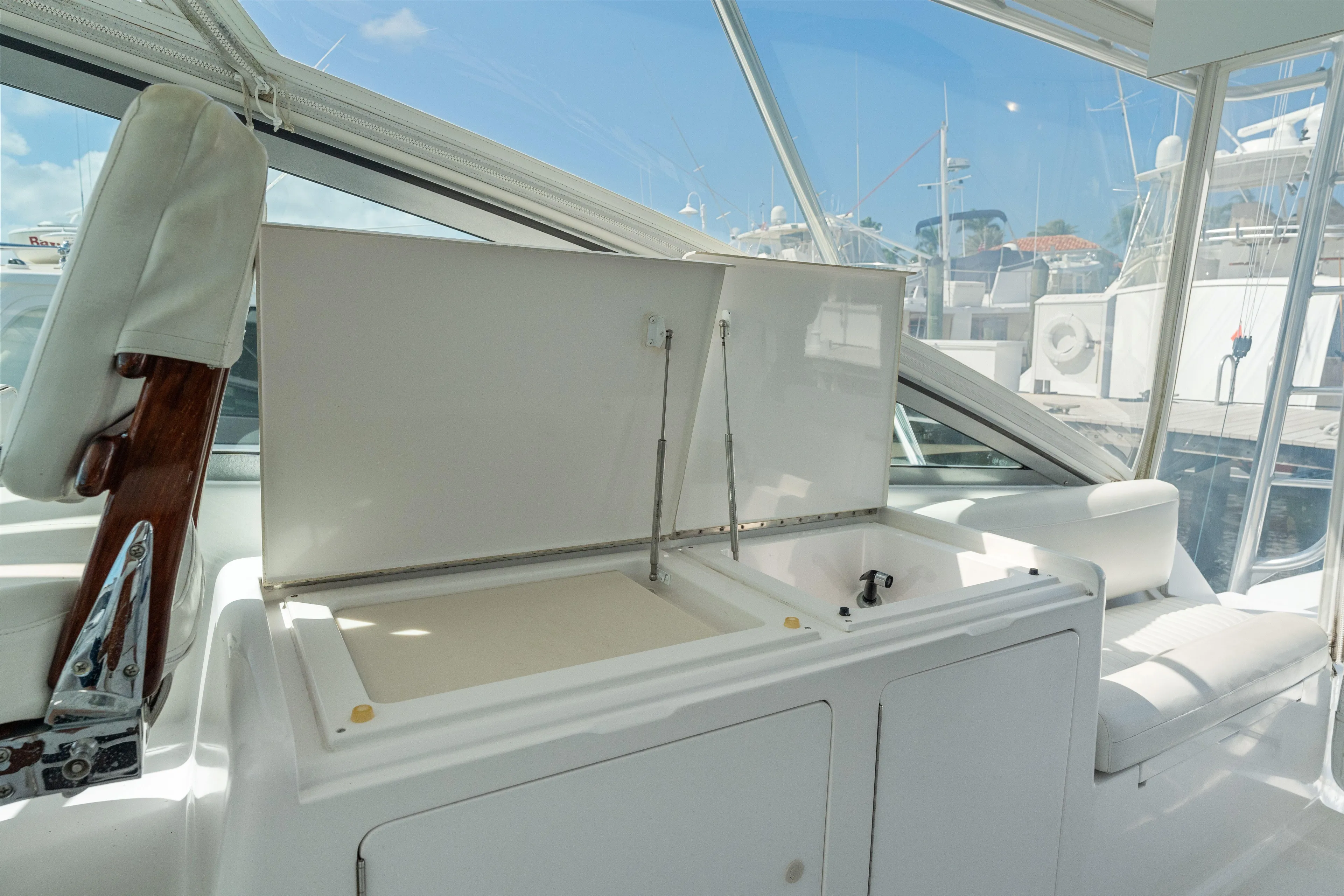 All Keyed Up Yacht Photos Pics 2001 Viking 50 Express yacht interior with open storage compartment and seating.