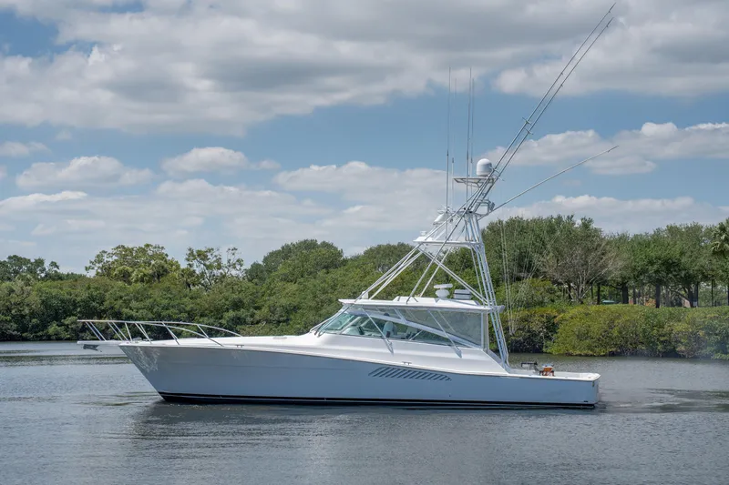 All Keyed Up Yacht Photos Pics 2001 Viking 50 Express yacht on calm water under a partly cloudy sky.