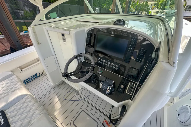  Yacht Photos Pics 2008 Yellowfin 42 Offshore boat cockpit with steering wheel and navigation controls.