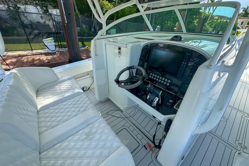  Yacht Photos Pics 2008 Yellowfin 42 Offshore boat interior with helm, steering wheel, and cushioned seating.