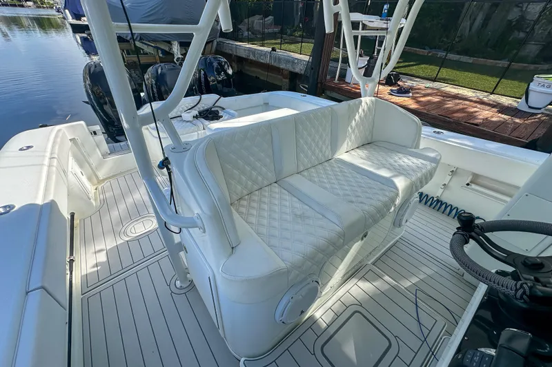  Yacht Photos Pics 2008 Yellowfin 42 Offshore boat interior with white quilted seating and dual outboard motors.