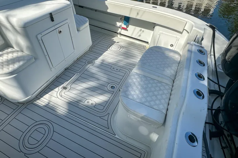  Yacht Photos Pics 2008 Yellowfin 42 Offshore boat interior with cushioned seating and rod holders.