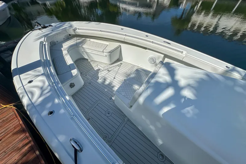  Yacht Photos Pics 2008 Yellowfin 42 Offshore boat interior with seating and storage, docked by calm water.