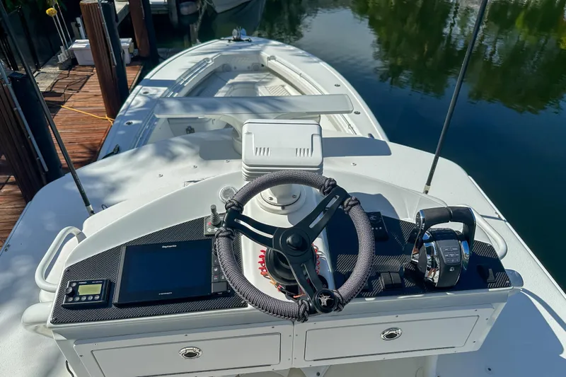  Yacht Photos Pics 2008 Yellowfin 42 Offshore boat helm with steering wheel and controls, docked by water.