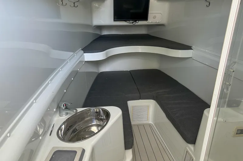  Yacht Photos Pics 2008 Yellowfin 42 Offshore cabin interior with sink, seating, and TV.