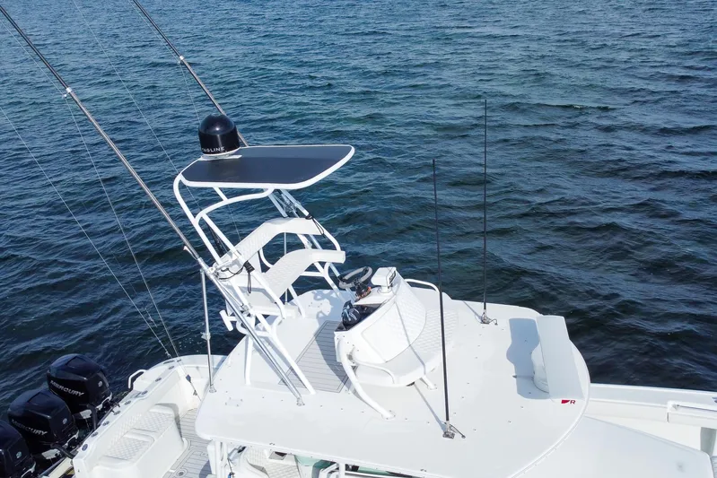  Yacht Photos Pics 2008 Yellowfin 42 Offshore boat with elevated helm, on calm water.