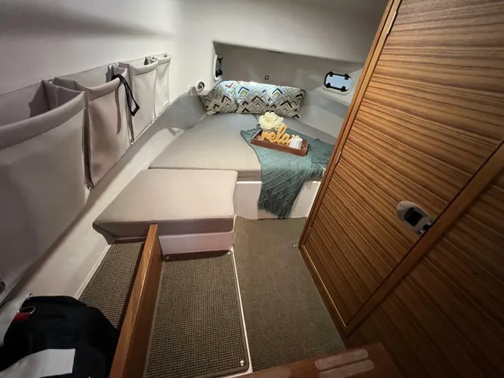 Ann #95 Yacht Photos Pics Cozy cabin interior of 2023 Nimbus T9 #95 boat with bed and storage.