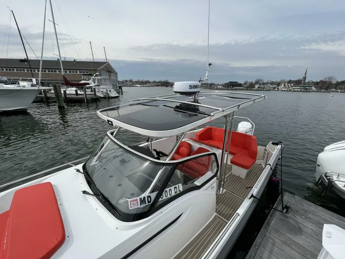 Ann #95 Yacht Photos Pics Nimbus T9 #95 2023 boat docked, featuring red seating and modern design.