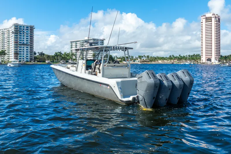 Four Reels Yacht Photos Pics 2021 Contender 44 CB boat with four engines on a sunny waterfront.