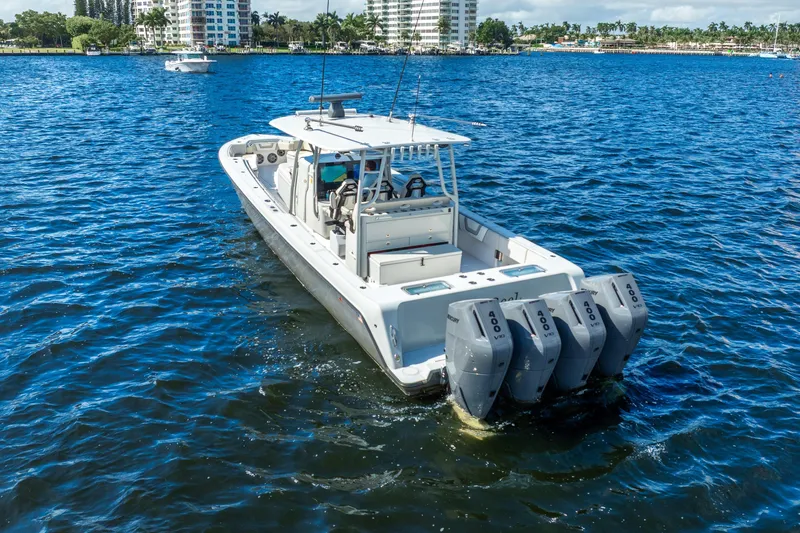 Four Reels Yacht Photos Pics 2021 Contender 44 CB boat with four outboard engines on blue water.