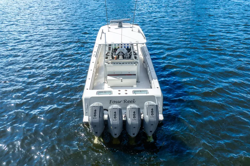 Four Reels Yacht Photos Pics 2021 Contender 44 CB boat with quad 400 engines on open water.