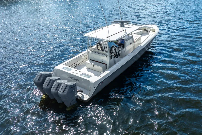 Four Reels Yacht Photos Pics 2021 Contender 44 CB boat on water, featuring four powerful outboard engines.