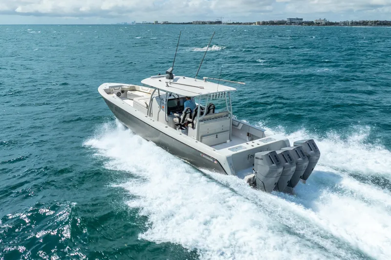 Four Reels Yacht Photos Pics 2021 Contender 44 CB boat cruising on open ocean with powerful outboard engines.