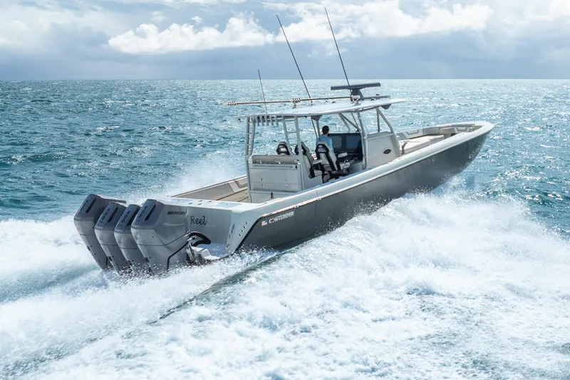 Four Reels Yacht Photos Pics 2021 Contender 44 CB boat cruising on open ocean with four outboard engines.