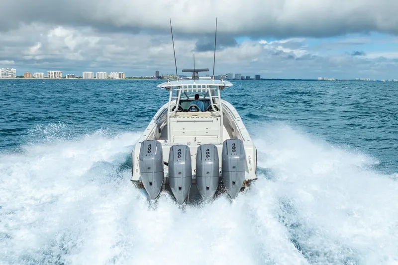 Four Reels Yacht Photos Pics 2021 Contender 44 CB boat with four engines cruising on open water.